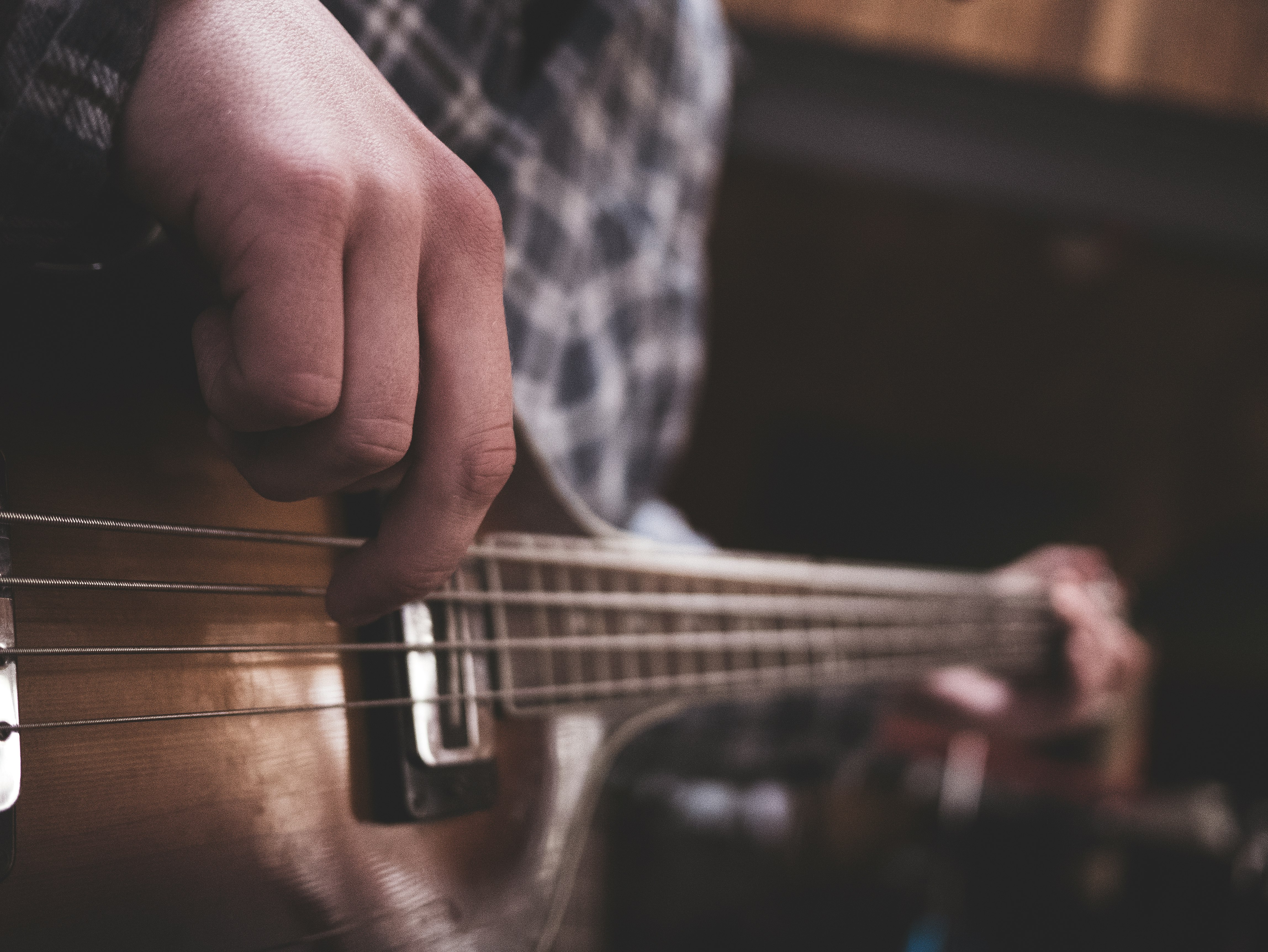 person playing acoustic guitar